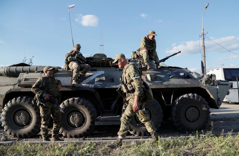 FILE PHOTO: Service members of pro-Russian troops stand guard in