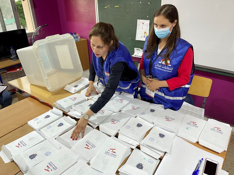 Electoral workers sort ballots after polls closed during Lebanon’s parliamentary