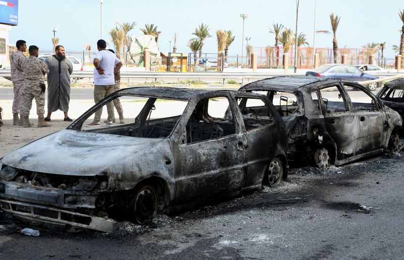 FILE PHOTO: Vehicles destroyed after fighting between soldiers loyal to