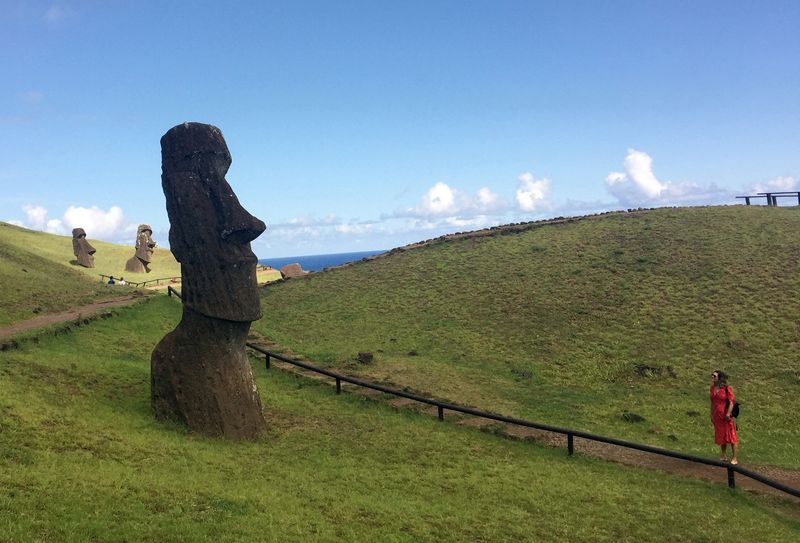FILE PHOTO: A tourist looks at a statue named “Moai”