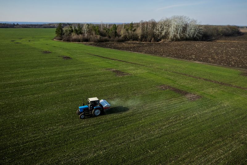 FILE PHOTO: An aerial view shows a tractor spreading fertiliser
