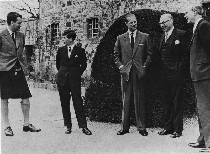Britain’s Prince Charles stands next to his father Prince Philip