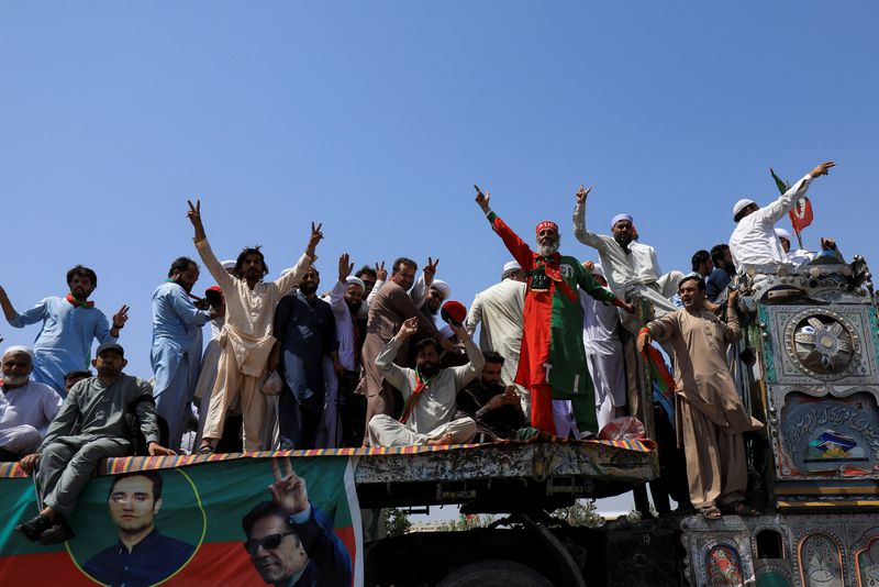 People attend a protest march led by ousted Pakistani PM