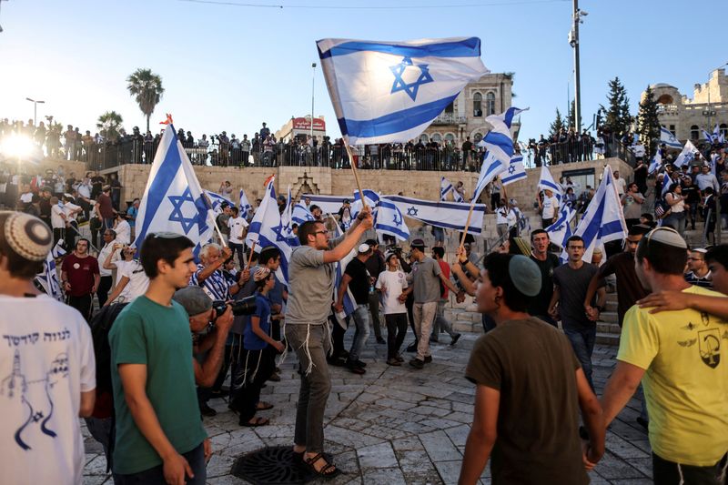 FILE PHOTO: Israelis dance with flags by Damascus gate just