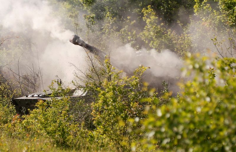 FILE PHOTO: A howitzer of pro-Russian troops fires in the